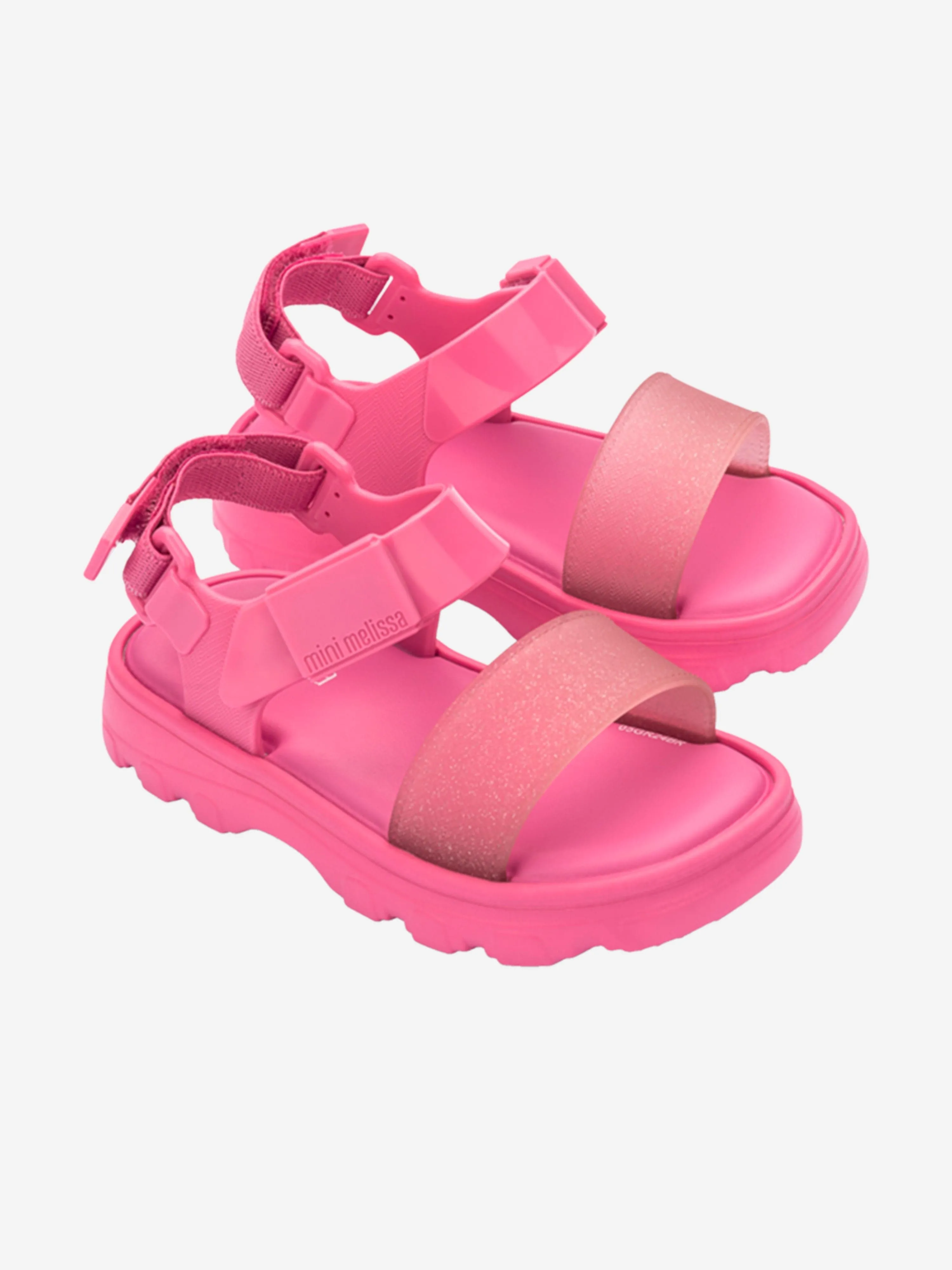 Mädchen stoßen Sandalen in Rosa ab